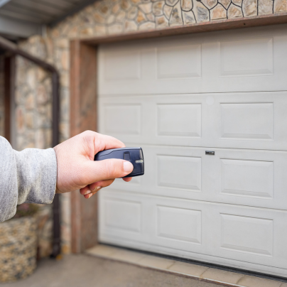Riverside security key fob pointing to a garage door